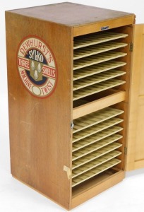 An early 20thC Dewhurst's Sylko Three Shells oak cased shop display cabinet, of two section form, each with an up and over glazed door enclosing six above seven shelves for cotton reels, 85cm high, 39cm wide, 43cm deep. - 2