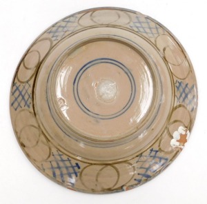 A late 20thC Studio pottery dish, painted centrally with a stylised bird, within a hatched and repeating fruit border, bears artist's seal marks, 39cm wide. (AF) - 3