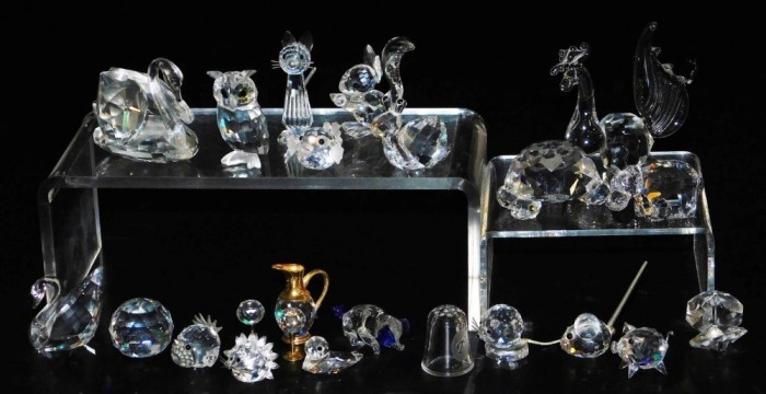A group of Swarovski and other crystal ornaments, including a hippopotamus, squirrel, standing cat, hedgehog and a puffer fish. (a quantity)