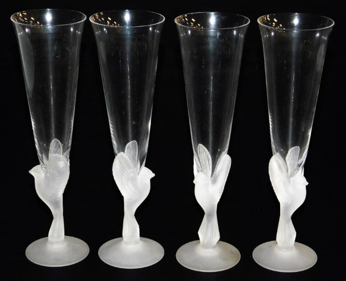 A set of four Sasaki Wings crystal champagne flutes, the clear tapering flute within a frosted glass bird stem, on a conical foot, 24cm high.