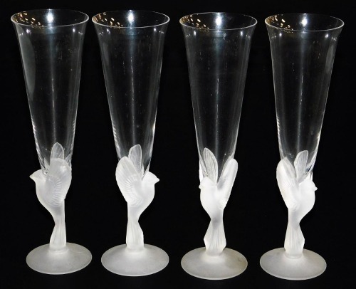 A set of four Sasaki Wings crystal champagne flutes, the clear tapering flute within a frosted glass bird stem, on a conical foot, 24cm high.