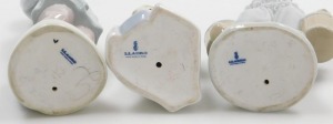 Three Lladro porcelain figures, comprising a boy in a dressing gown with a stool behind, Dutch boy holding two milk pails (AF), and a kneeling figure of a girl. (3) - 2