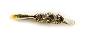 An 18ct gold, platinum and diamond three stone ring, claw set, approx 1/8th carat, size R, 1.9g.