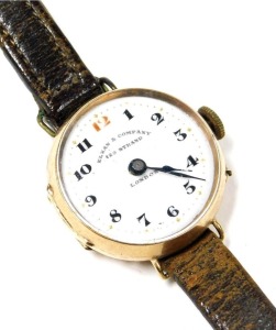 An early 20thC rose gold cased wristwatch, for Elkan & Company, 129 Strand London, circular enamel dial bearing Arabic numerals, Swiss movement, plain case, on a leather strap.