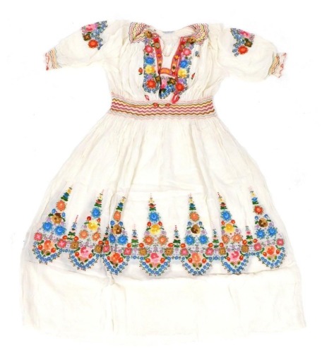 A mid century Hungarian wedding dress, embroidered with flowers, in a box, with provenance to base.