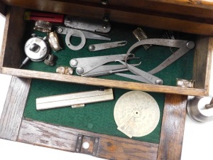 An early 20thC oak tool chest, with a drop down front enclosing four graduated drawers with recess below, holding some tools, 26cm x 41cm x 19cm. - 2