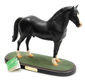 A Beswick matt black figure of Welsh Cobb Stallion, raised on an oval base, printed mark.
