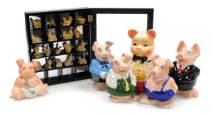 A set of five Nat West piggy banks, together with various Wade Whimsies, in a wall mounted display case, and an Ellgreave pottery Mr Pig piggy bank. (a quantity)