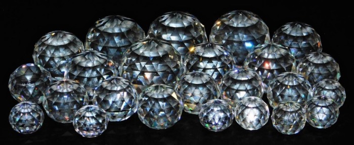A group of faceted crystal paperweights, plain and various colour ways. (a quantity)