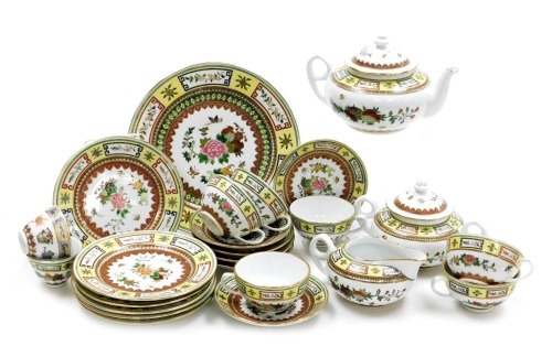 A 20thC Chinese yellow ground porcelain part tea service, famille rose decorated with flowers and butterflies, printed marks, comprising teapot, sucrier, cream jug, bread plate, six tea cups, saucers and plates, together with two tea bowls.