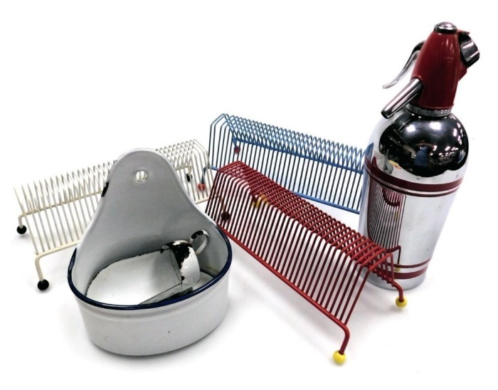 Three 1950's atomic record racks, an enamel ware scoop, wall hanging soap dish with drainer, and a Sparklets Limited soda siphon, model SG2.
