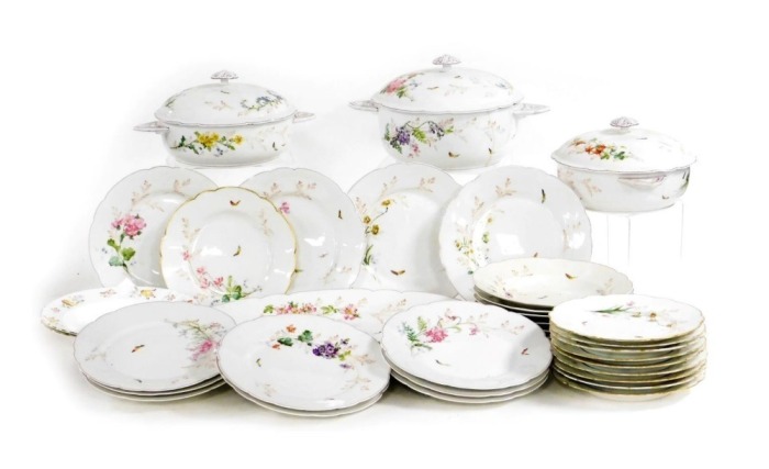 An early 20thC French porcelain part dinner service, for Mansard of Paris, painted with sprays of flowers and butterflies, including tureens and covers, meat platter, dinner, dessert and soup plates. (a quantity)