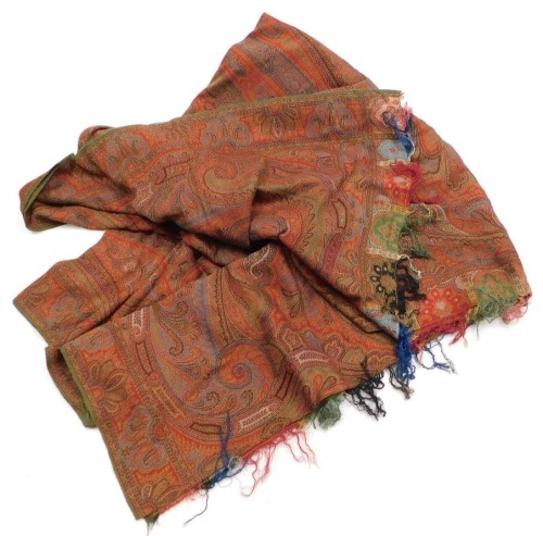 A vintage Paisley shawl, traditionally decorated against a red ground, 324cm x 161cm.
