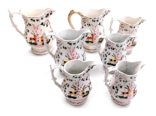 Seven 19thC graduated pottery jugs, each moulded and lustre decorated with deer and trees. (AF)