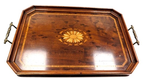 An early 20thC plum pudding mahogany and inlaid tray, decorated centrally with a floral patera, within a border of flowers and harebells, with satinwood crossbanding, 56cm wide.