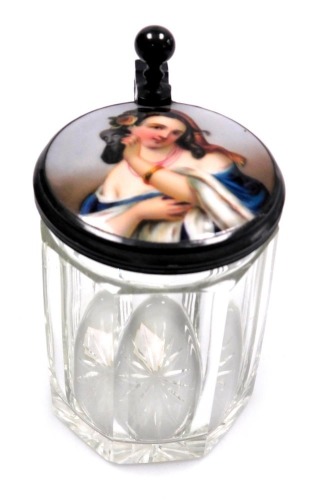 A late 19thC German cut glass stein, with a hinged pewter and porcelain inset lid, painted with a half length portrait of a lady holding a mask, 12cm high.