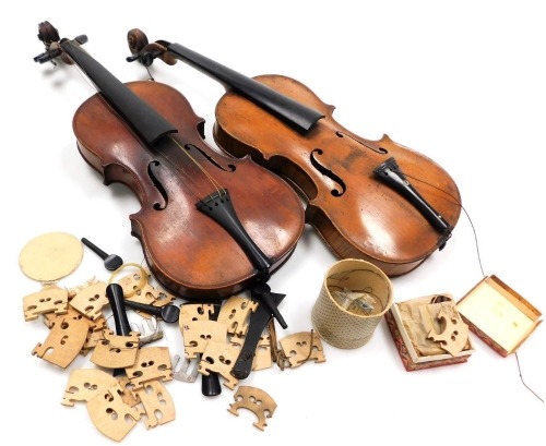 A violin, with a single piece back, bearing label for a copy of an Antonio Stradivari violin 1721, 59cm high, further violin with a two piece back and assorted violin bridges, peg tuners, tail pieces, etc. (a quantity)