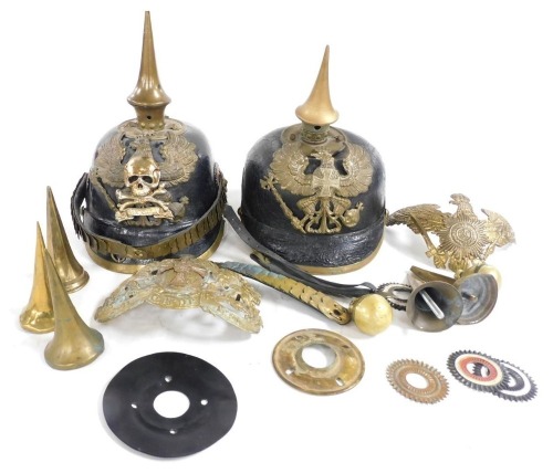 Two Pickelhaube, one finished in black leather, on finished in green fabric, two Pickelhaube badges, various Pickelhaube items, including spikes for other ranks and officers, also for artillery and three roses, two straps, etc.