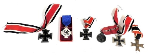 Three German Iron Crosses, second class, and associated medals.