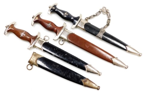 Three reproduction German daggers and one sheath.