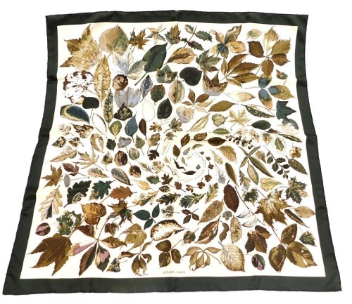 A Hermes silk scarf, decorated with autumnal leaves, 86cm x 86cm.