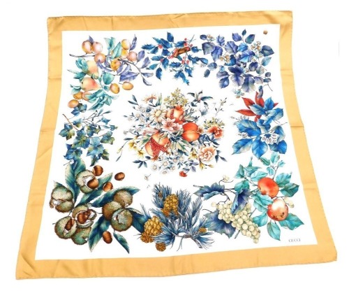 A Gucci silk scarf, decorated with fruit and other foliage, to include pomegranates, apples, grapes, horse chestnuts, pears, other berries, etc., 85cm x 85cm.