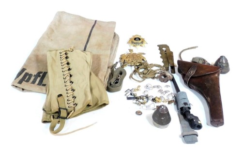 Various WWI and later militaria, including a detonation cap, adjustable for time detonation for fifteen pound shell, another cap for a five pound shell, bayonets, two badges, cleaning materials, webbing, cap badges, etc.