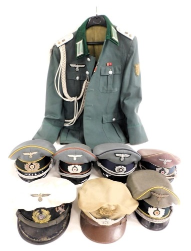 Six German military peak caps, including Kriegsmarine, Signal Officer's, etc., an American Air Force cap, and a German officer's tunic.
