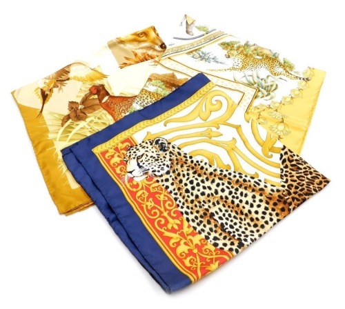 Three silk Salvatore Ferragamo silk scarves, one decorated with elephant, lion, cheetah, tiger, and leopard, the other with a tiger, cheetah, and leopard, and the third hunting related depicting various woodland animals and a figure of a huntsman on horse
