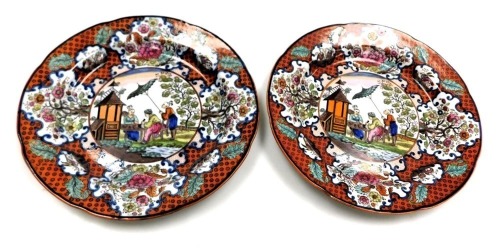 A pair of early 19thC pearl ware and clobbered plates, decorated in The Doctor Calling pattern, 24cm wide.