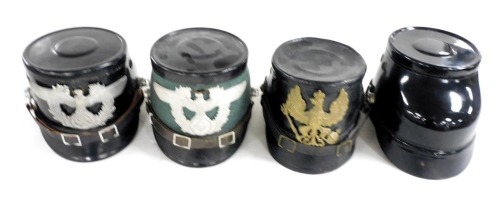Four German Civil police helmets, two bearing German Reichstag eagle with Nazi Swastika, one earlier and a further helmet.
