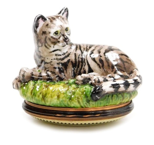A Halcyon Days enamel and porcelain bonbonniere, modelled as a seated cat, 5cm high, boxed.