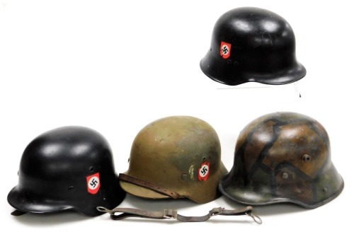 Three German steel M40 helmets, and one earlier. (4)
