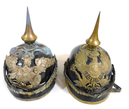 Two early German Pickelhaubes, one bearing crest for Colberg 1307, the other with the Prussian Eagle.