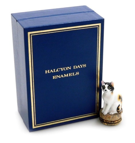 A Halcyon Days porcelain and gilt silver mounted seal, modelled as a seated cat on a rockwork base, 5cm high, boxed.