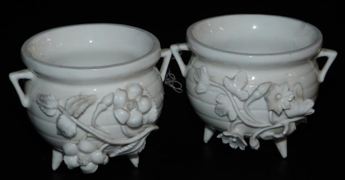 A pair of late 19thC Stevenson and Hancock Derby porcelain salts, of white glazed cauldron form, encrusted with flowers, blue printed mark, 8cm wide.