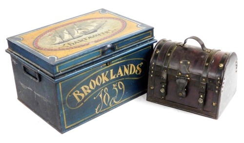 A Victorian metal trunk, later painted, the lid with a sailing clipper 'Dartmouth', the front with 'Brooklands 1859', 29cm high, 47.5cm wide, 35.5cm deep, together with a wooden and leather bound domed casket, 23cm high, 30cm wide. (2)