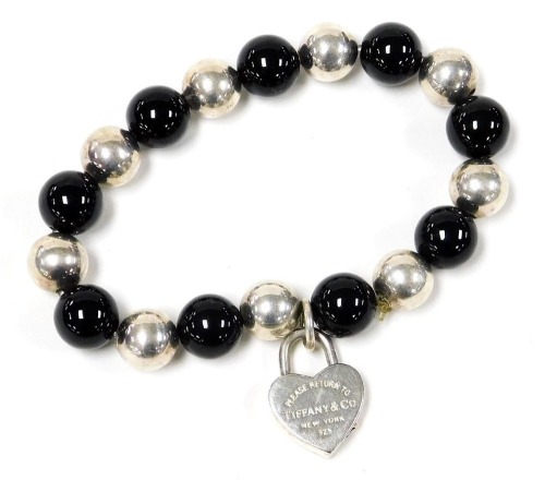 A bracelet, formed of black agate and white metal alternating beads, with a heart shaped padlock, marked please return to Tiffany & Company New York, 925, in a Tiffany & Company box.