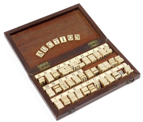 A Victorian bone alphabet set, including numerals, Arabic and Roman, in a box stamped Calvert, 189 Fleet Street.