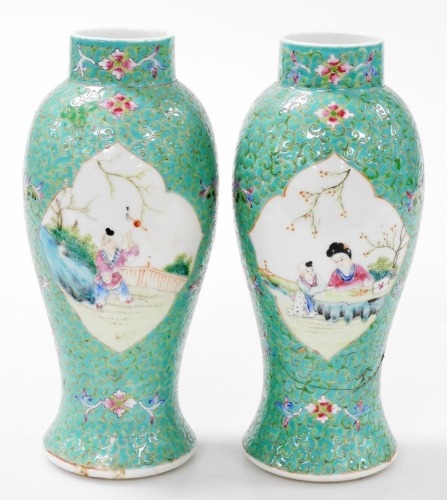 A pair of Chinese Republic famille rose porcelain vases, of baluster form, decorated with reserves of a mother and child in a garden, and a child playing, within a turquoise ground decorated with flowers, 26cm high. (AF)