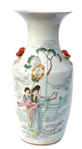 An early 20thC Chinese porcelain vase, of shouldered cylindrical tapering form with a flared neck, decorated with coloured enamels depicting two women before steps painted verso with characters, with two applied red mask handles, against an off white grou
