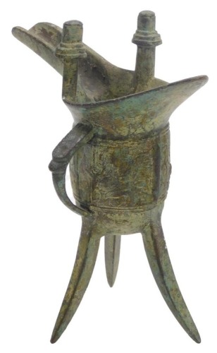 A Chinese bronze three legged wine vessel (jia), in archaic style, 17.5cm high.