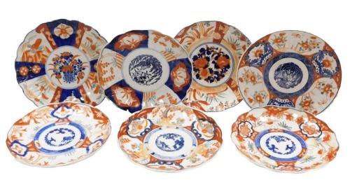 Seven Meiji period Japanese porcelain Imari plates, each of scalloped form, each variously decorated, some with transfer printed designs, each 22cm diameter.