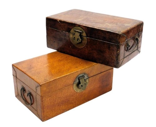 Two late 19thC Oriental leather trunks, each with brass ring handles and lock plate, 32cm wide and 31cm wide.