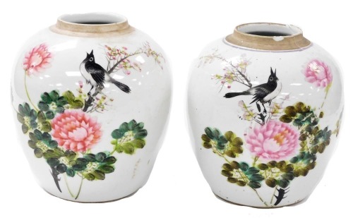 A pair of 20thC Chinese famille rose porcelain ginger jars, covers lacking, painted with magpies and flowers, verso script, 23cm high. (AF)
