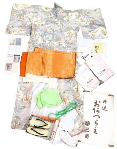 A 20thC Japanese silk Kimono, in grey decorated with flowering branches in oranges, blues and greens, orange waist tie, smaller section of green silk, further ties, padding, pair of geta, etc.