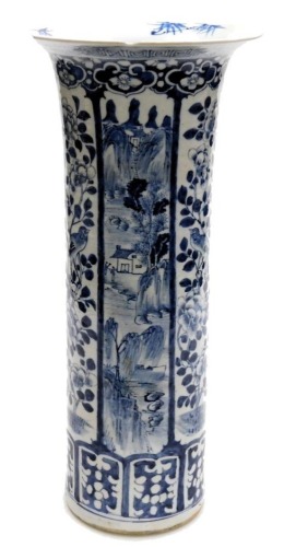 A Chinese cylindrical blue and white vase, with flared rim, painted with panels of landscape decoration and birds with flowering shrubs, within lappet borders, 45.5cm high.