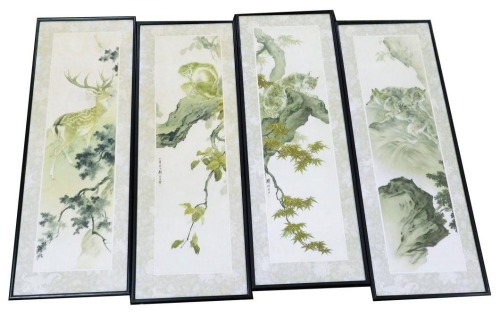 A set of four reproduction Chinese prints, depicting a deer, monkeys, wolves, and a lynx, within a naturalistic setting, 67cm x 26cm.