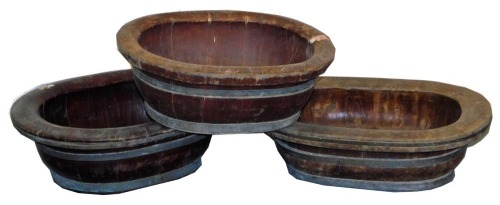 Three graduated oval Oriental bowls, with brass banding, 53cm down.