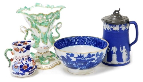 A group of 19thC ceramics, including a pearl ware blue and white bowl, chinoiserie decorated, Rockingham style vase, Wedgwood dark blue Jasper water jug, with hinged lid, sprigged with classical figures, and a Mason's Ironstone hydra jug. (4)
